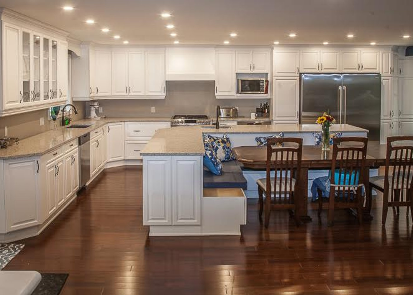 Bright renovated kitchen with white oak cabinetry and a sage green island